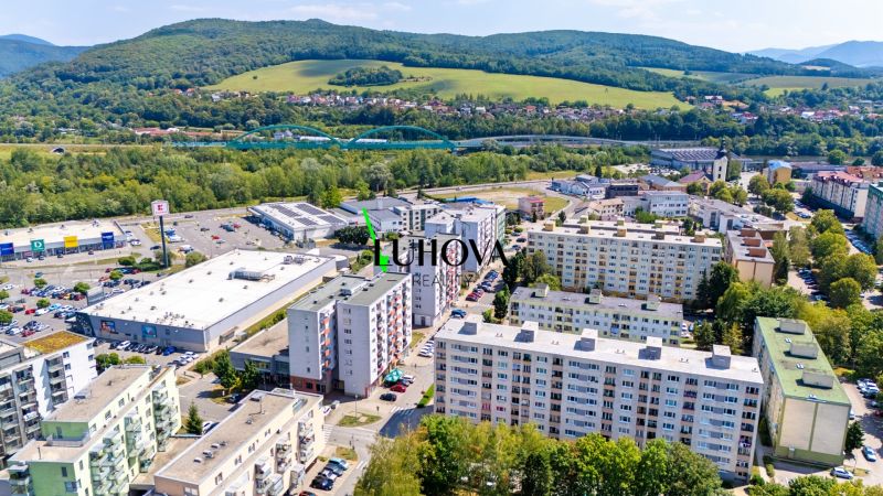 A view of commercial spaces and residential buildings on Dvory Street in Púchov.
