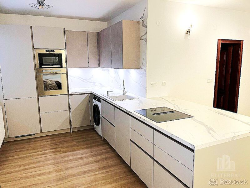 A kitchen in a 3-room apartment with white cabinets and a wooden decor floor.