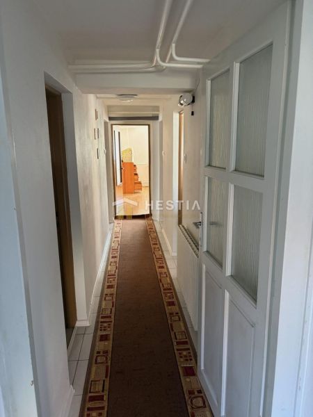 Narrow interior with carpet in a family house, long corridor.