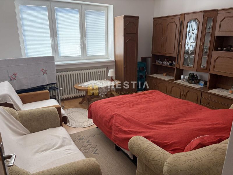 A room in a family house with wooden decor and comfortable furniture.
