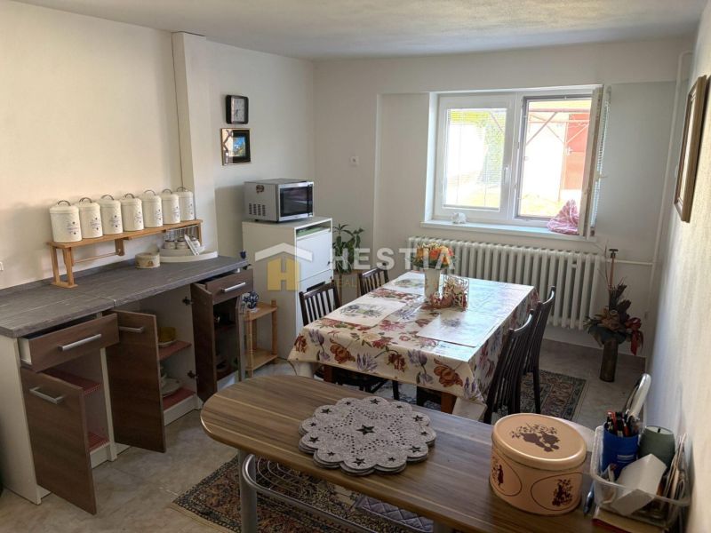 Kitchen with a dining table and a window in a family house.