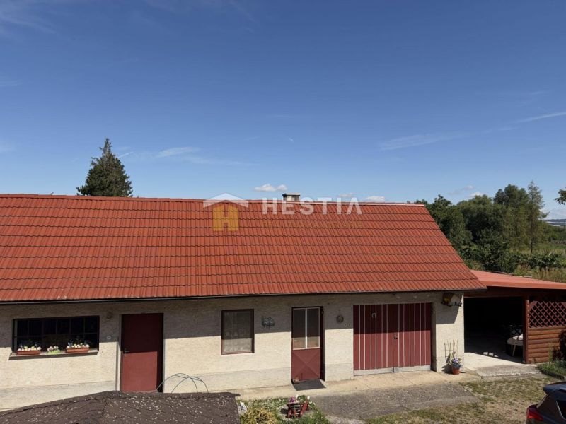 A family house in Šajdíkovce Humence with a red roof and a garage.