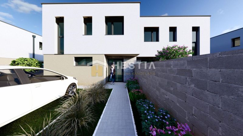 A modern house facade with a car and a landscaped garden in Rovensko.