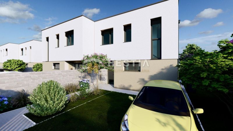 A two-story house in Rovensko with a well-maintained garden and driveway, parked car.