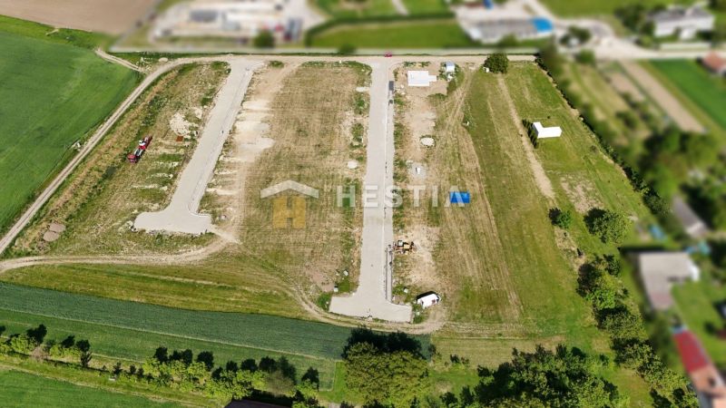 Aerial view of land - housing in Rovensko with divided plots and a road.