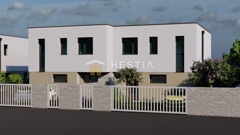 A two-story building with trees and a fence in Rovensko.