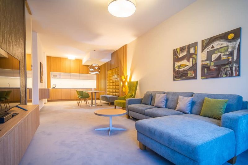 Living room in a holiday apartment with a comfortable sofa and a wooden decor floor.