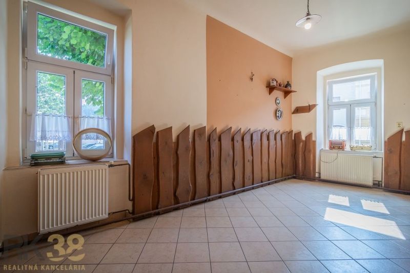 Gastro premises with tiles, decorative wood, and large windows, cozy and bright.