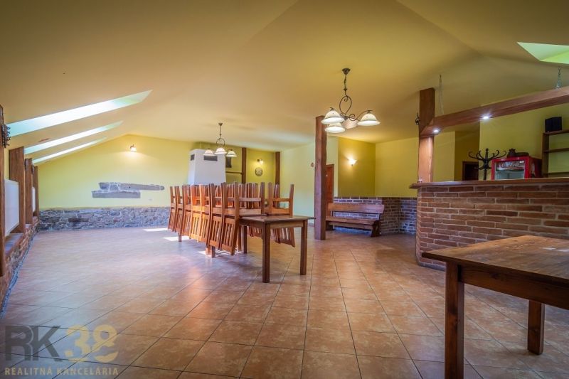 Gastro premises with a brick bar and tables, floor with wooden decor, light decoration.