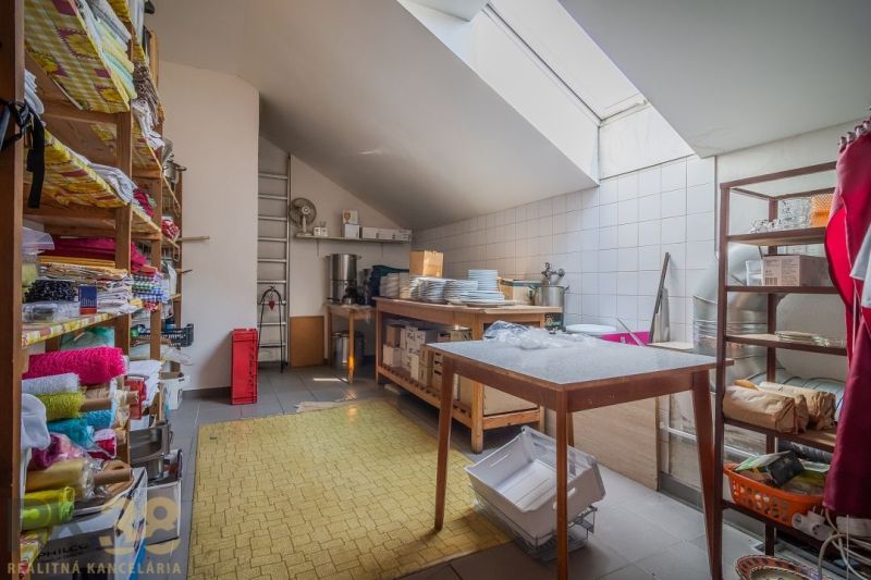 Organized storage space with shelves in gastro areas, with natural light through a skylight.
