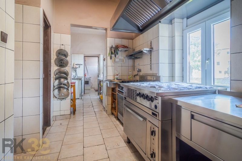 Professional kitchen with appliances and stainless steel surfaces in catering spaces.