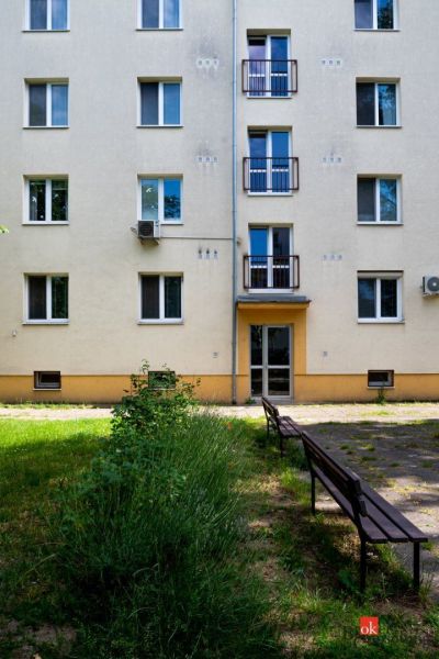 Apartment building with benches and greenery on Herlianska Street in Bratislava-Ružinov.