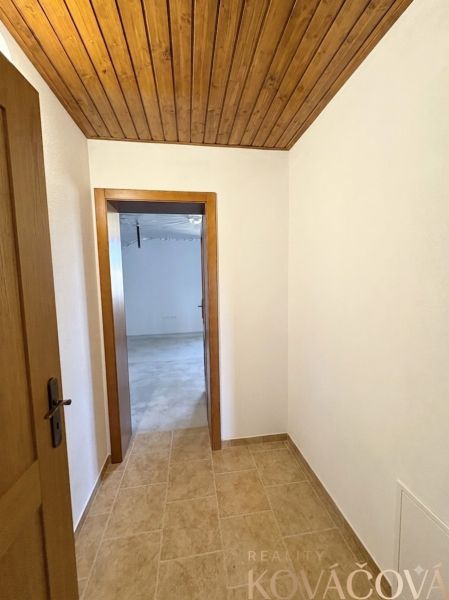 Interior of a family house with a wooden ceiling and paneling, floor with wooden decor.