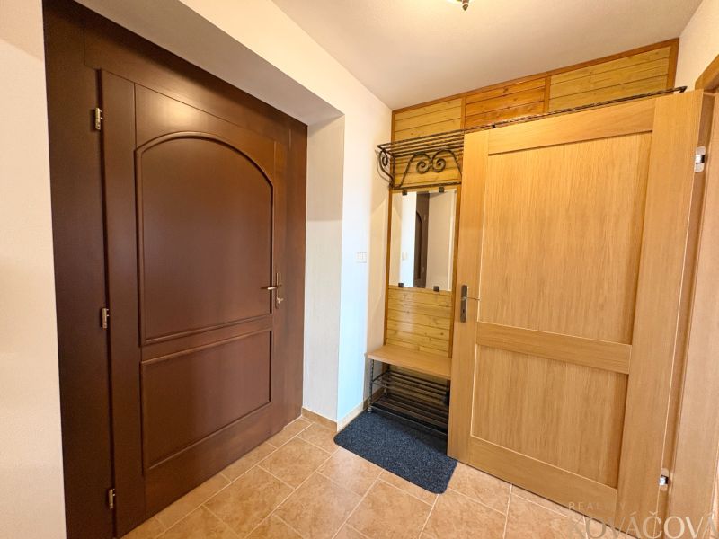 Interior of a family house with wooden decor doors and a practical coat rack.