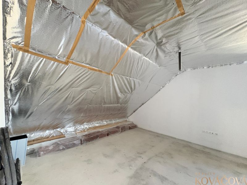 Attic room with insulation and ready for finishing in a family house.