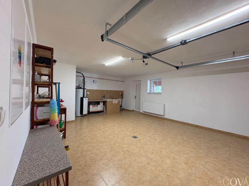 A garage with a shelf and a work area in a family house.