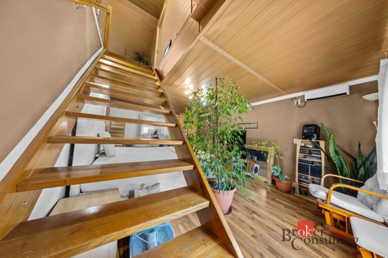 Wooden stairs and furniture in the interior of a family house with a wooden decor floor.