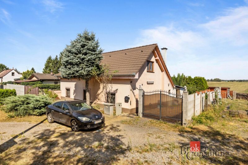 A family house in Veľké Leváre, a car on the driveway, a garden, and part of the fence.