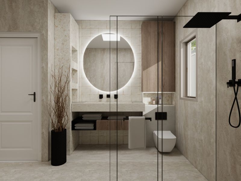 Bathroom in a family house with a large round mirror and a shower screen.