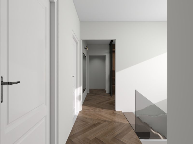 A hallway in a family house with a wooden decor floor and white walls.
