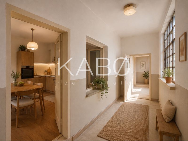 Interior of a family house with a kitchen and hallway, wooden decor flooring, plants.