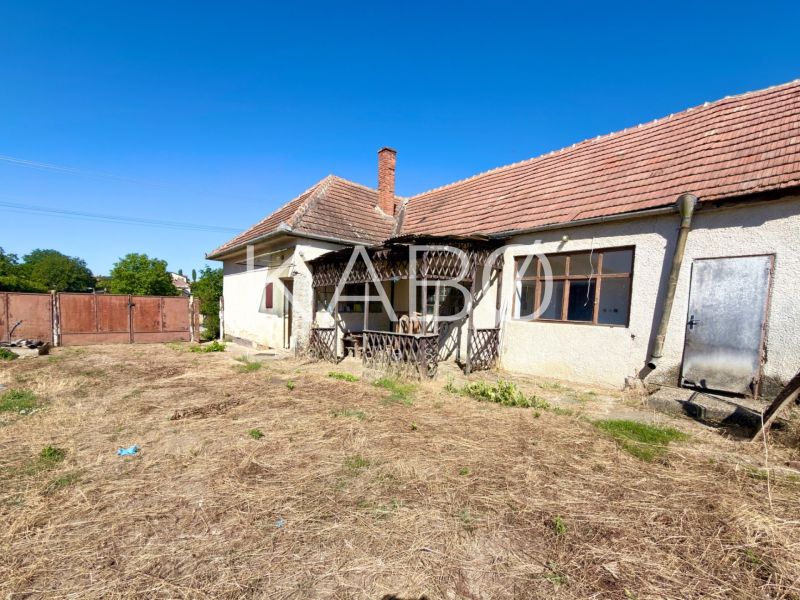 A family house in Hruboňovo with an older exterior and extensive land.