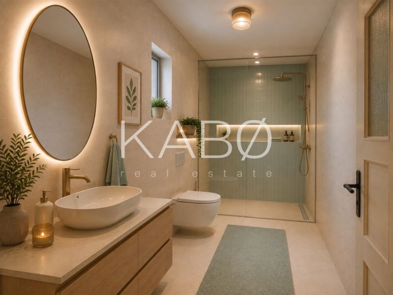 A bathroom in a family house with a shower and an oval mirror.