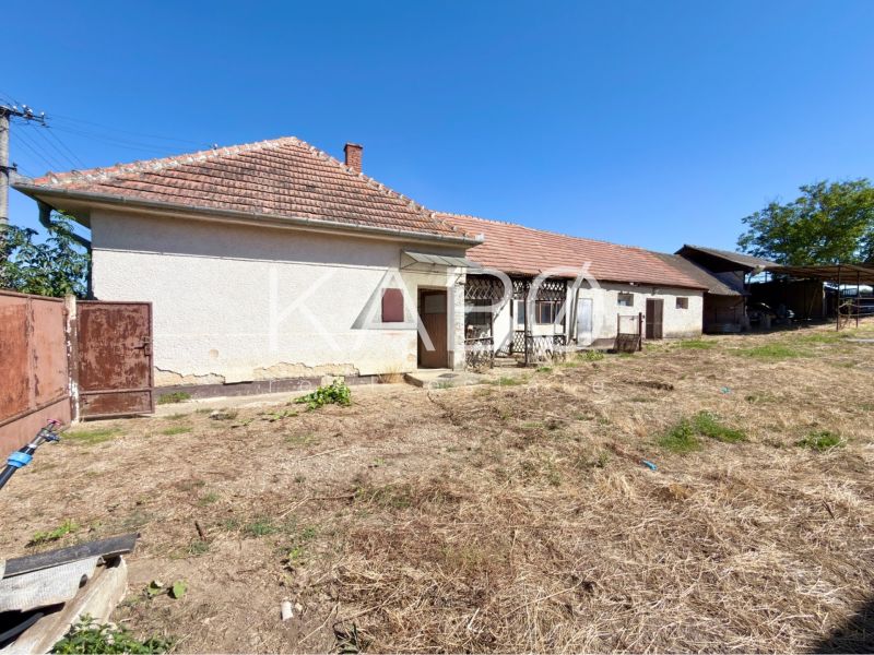 A family house in Hruboňovo with land and farm buildings in the countryside.