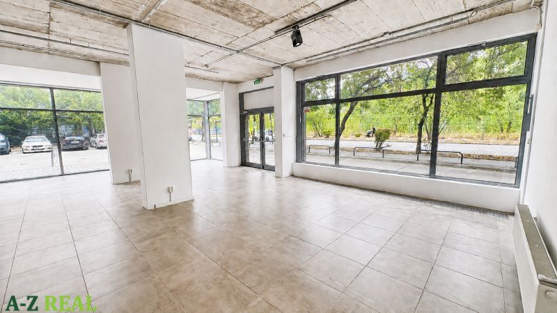 Spacious commercial premises with large glass display windows and tiling.