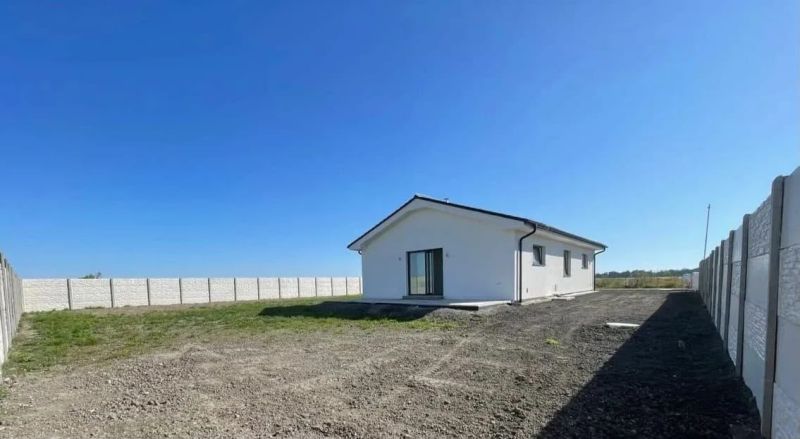 A family house in Bellova Ves with a white facade and a grassed garden.