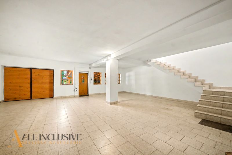 Spacious interior with tiles, stairs, and entrance doors, suitable for Land - housing.