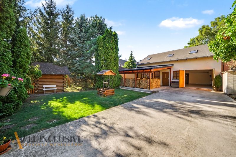 Garden yard with wooden structures and grassy area in Pezinok, Residential plots.