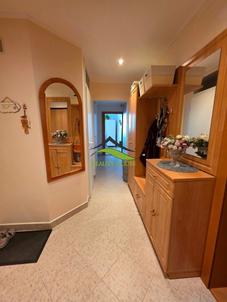 A hallway with a mirror and wooden decor in a 3-room apartment.