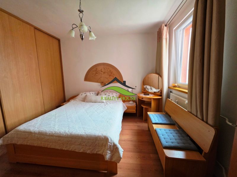 A bedroom in a 3-room apartment with a double bed, a built-in wardrobe, and a floor with a wood decor.
