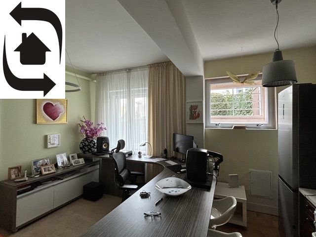 Study in a villa with equipment including a desk, chair, and decorations.