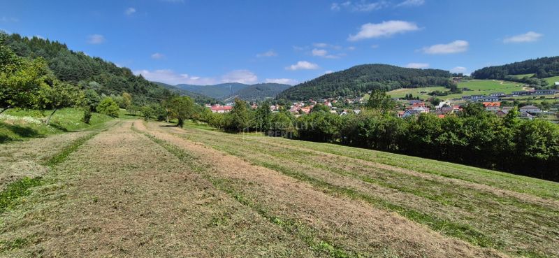 Plots - living in Nesluša, surrounded by green hills and scattered buildings.