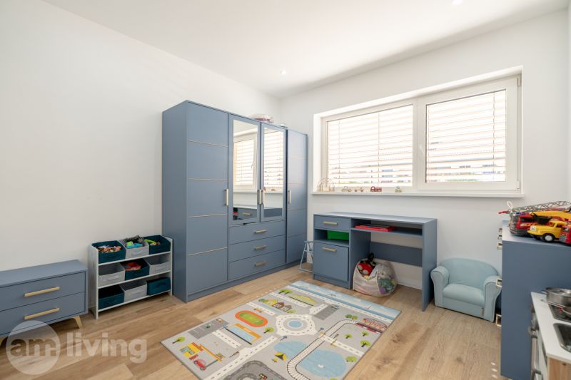 Children's room with blue furniture and a wooden decor floor in a family house.