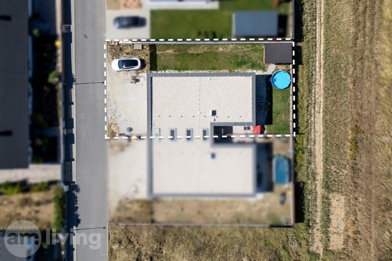 Aerial view of a family house in Trenčianske Jastrabie, yard with a car and a swimming pool.