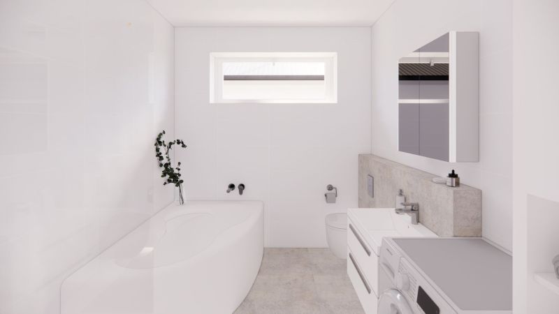 White bathroom in a family house with a bathtub, mirror, and toilet.