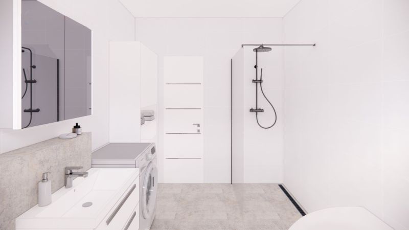 Bathroom in a family house with white tiles, a shower, and a washing machine.