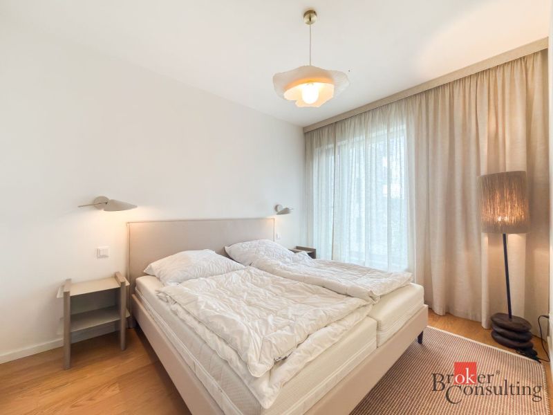 A bedroom in a 4-room apartment with a comfortable bed and a floor with a wooden decor.