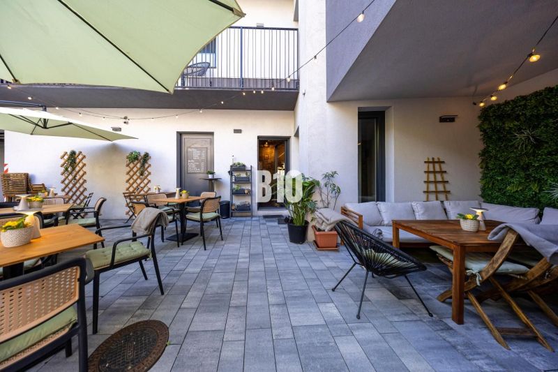 Outdoor gastro spaces in Bratislava - Old Town with tables and greenery.