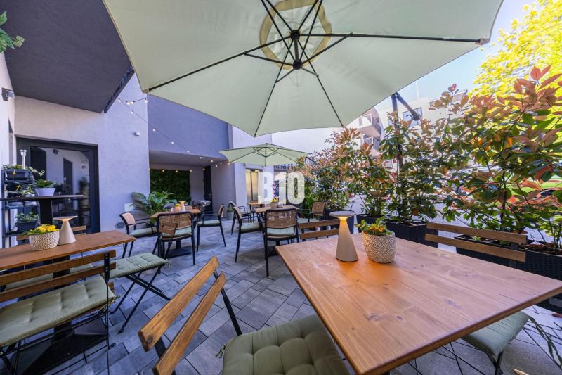 Outdoor dining areas in Bratislava - Old Town with wooden tables and umbrellas.