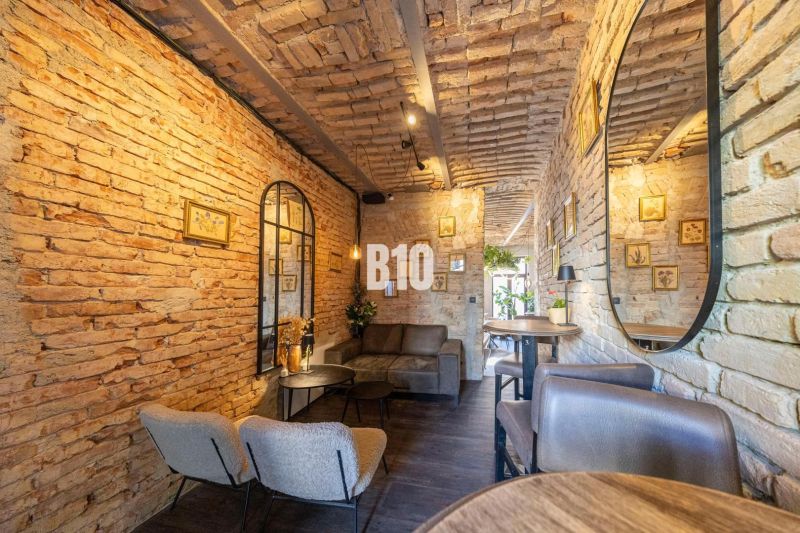 Interior of gastro spaces with brick walls and wooden decor flooring.