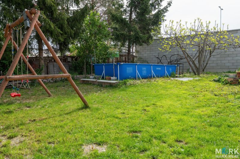 Garden in Dunajská Lužná, Kováčska, with a swing and a pool, ideal for residential plots.