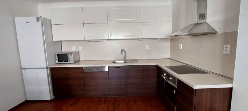 Kitchen with microwave and refrigerator, wooden decor flooring, 3-room apartment.