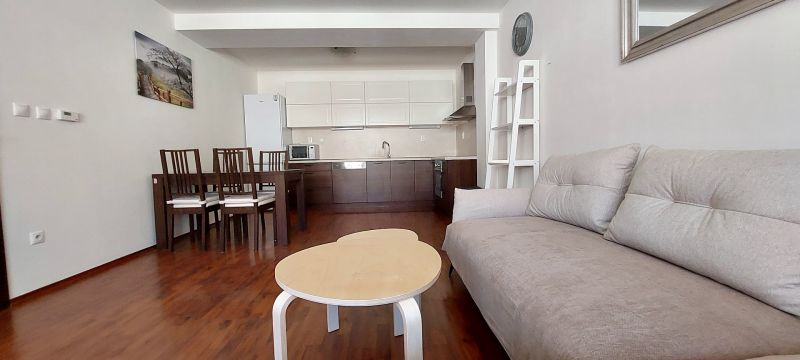 Living room in a 3-room apartment with a kitchen, floor with a wood decor.