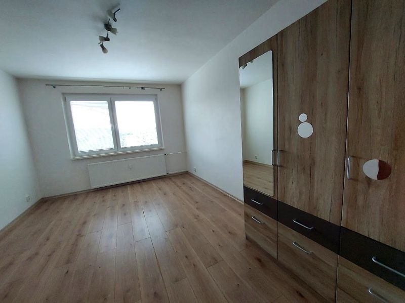 A room with a wooden floor decor and a wardrobe in a 3-room apartment.