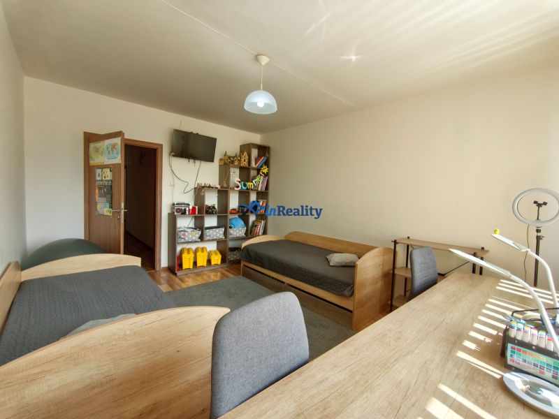 Children's room with two beds, a desk, and a shelf in a 3-room apartment.