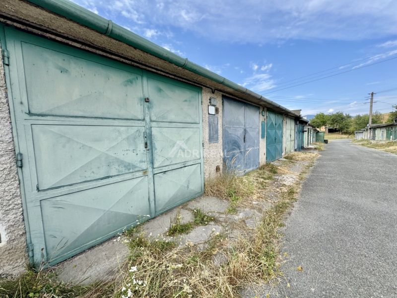 A row of garage doors in Detva on an asphalt road.
